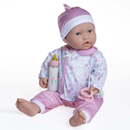 A 20 inch soft body baby doll with a white and pink outfit, including a pacifier and magic bottle.