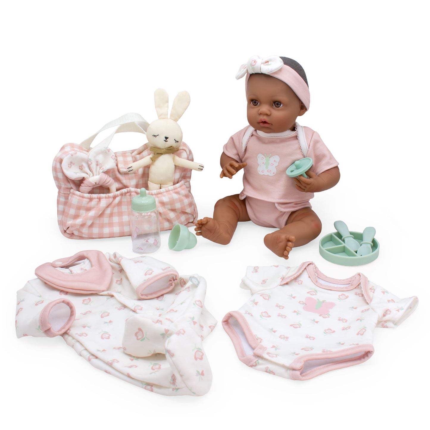 Baby doll with pink outfit and accessories on a white background