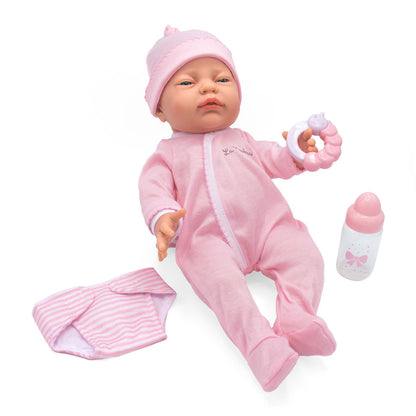 Baby doll in pink outfit with accessories on a white background
