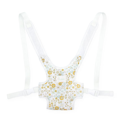 A baby hip seat support harness with adjustable white shoulder straps and a white fabric body decorated with a gold and light blue floral pattern, shown against a plain white background.