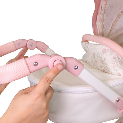 Pink baby stroller handle with a hand adjusting it, on a white background