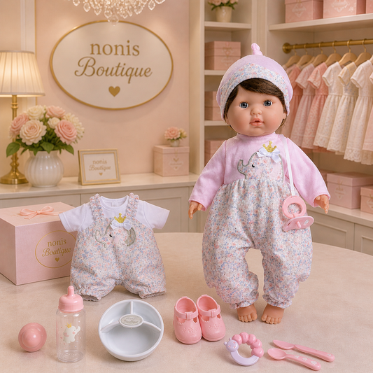 Baby doll with outfit and accessories in a store setting with 'nonis Boutique' branding.