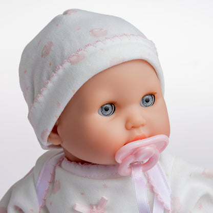 Realistic 12.5" baby doll with blue eyes, pink pacifier, white hat, and pink polka dot outfit.