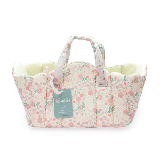 Floral-patterned baby carrier with a visible brand tag on a white background