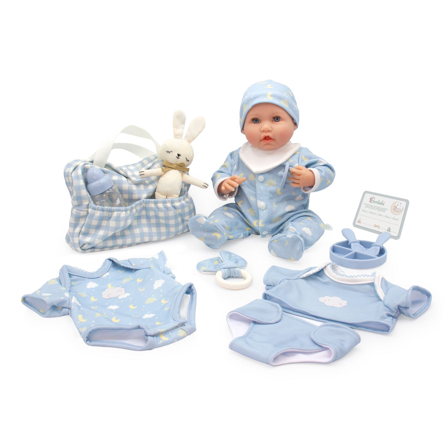 A baby doll play set on a white background, featuring a soft plastic baby doll in a light blue outfit with a matching hat, a blue-and-white gingham diaper bag with a white bunny plush inside, a light blue long-sleeve romper, a matching short-sleeve top, a light blue footie, a pacifier clip, and a small instruction card.