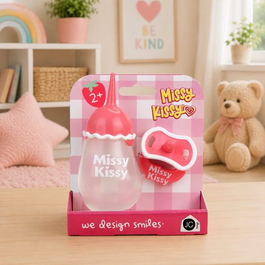 Missy Kissy product packaging on a table with a teddy bear and decorative items in the background