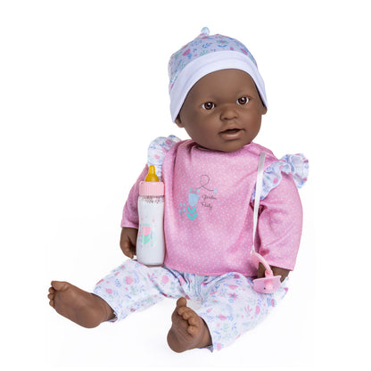 A 20 inch soft body baby doll with a pink and white 3 piece outfit, holding a pacifier and a magic bottle.
